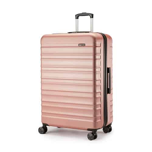 Valise rigide grande Amazon Basics 78 cm extensible or rose 105 litres